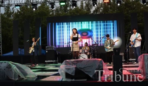 Band club 'LOTUS' members perform on stage on the first day of the festival.