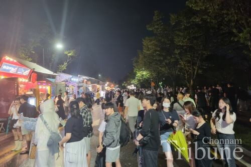A variety of booths draw a crowd on the first day of the festival.