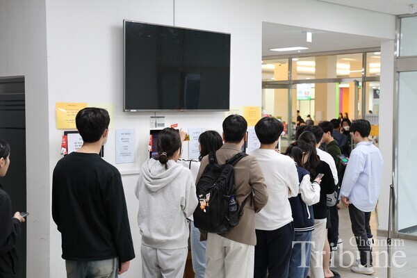 Students stand in line to buy a dinner ticket on April 17.