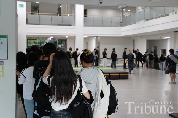 Students stand in line to buy a dinner ticket in front of the cafeteria located on the first floor of the Student Union 1 building on April 17.