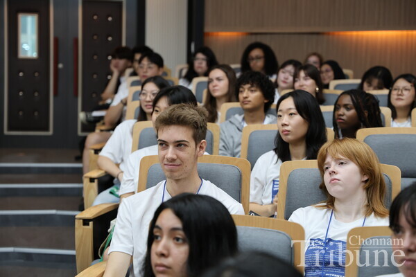Students listen to the ISS schedule during the opening ceremony.
