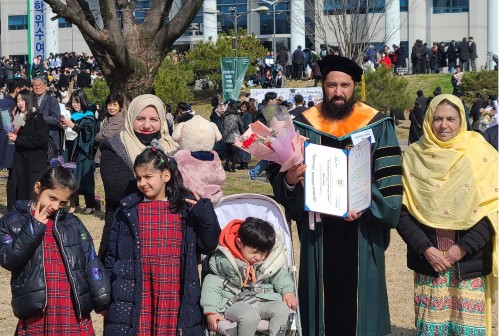 Shrif Saqib, second from right, and his family pose for a picture after the graduation ceremony on February 26.