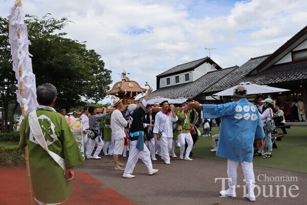 People carry an “omikoshi”, a portable shrine for the gods, during the Kawaba festival on July 28.