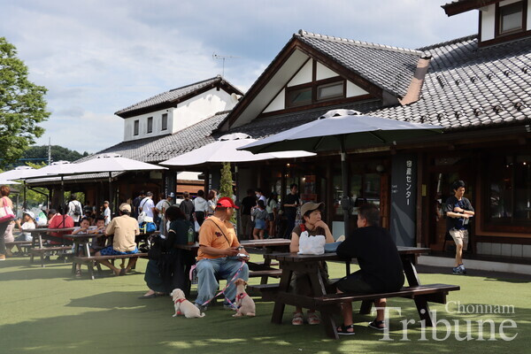 People relax at Denen Plaza in Kawaba Village on July 28.