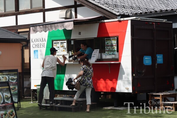 A vendor sells Kawaba Cheese at Denen Plaza on July 29.