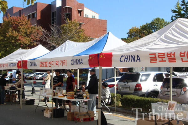 The staff at international food booths get dressed in their traditional costumes.