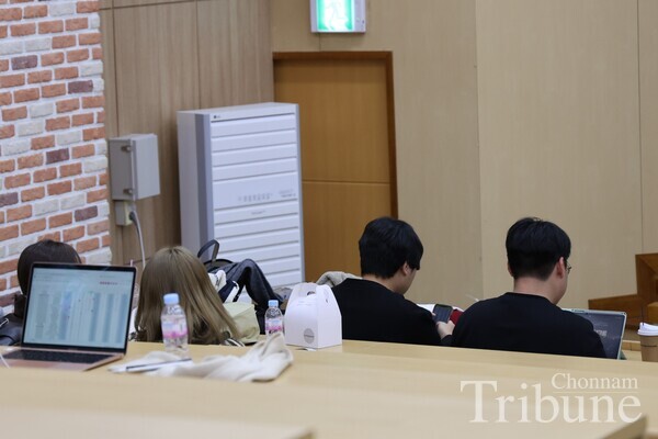 Attended students are watching the voting counting.