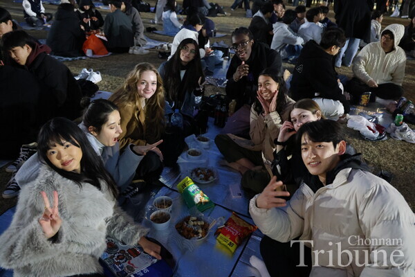 Buddy group members and their friends pose for a picture at the night market held at CNU on March 6.