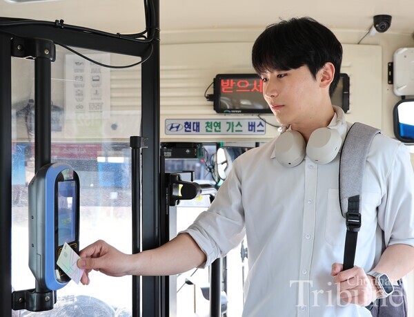 A student scans his G-Pass card to take a bus near Chonnam National University