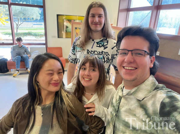 Raon Park poses for a picture at the exhibition opening with her photography club members.