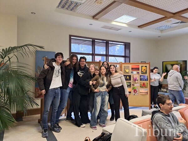 Raon Park poses for a picture at the exhibition opening with her photography club members.
