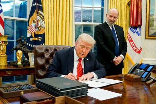 President Donald Trump, joined by Secretary of Commerce Howard Lutnick, signs an executive order on reciprocal tariffs in the White House Oval Office on Feb. 13. / CNN