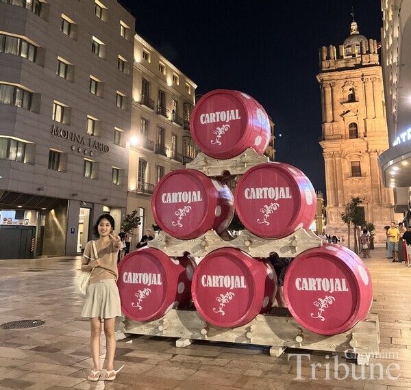 Im Ga-yeon poses in front of a wine barrel sculpture at the festival.