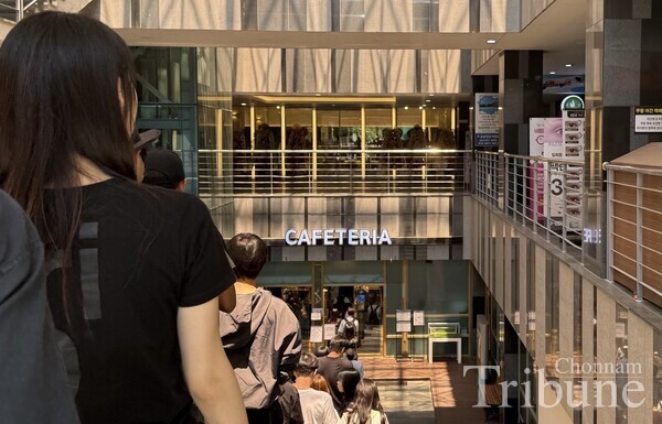 Students line up waiting to enter the cafeteria at peak lunch time.
