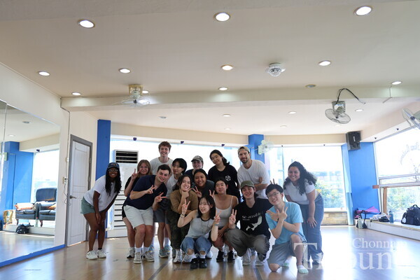 CLS students pose for a group photo after finishing K-pop dance class.