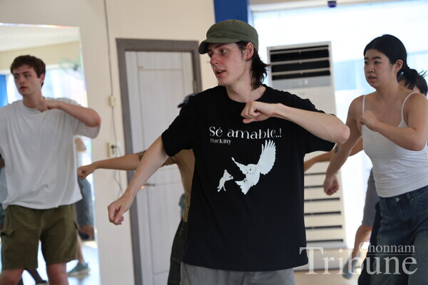 A student working hard to learn the dance movement perfectly.