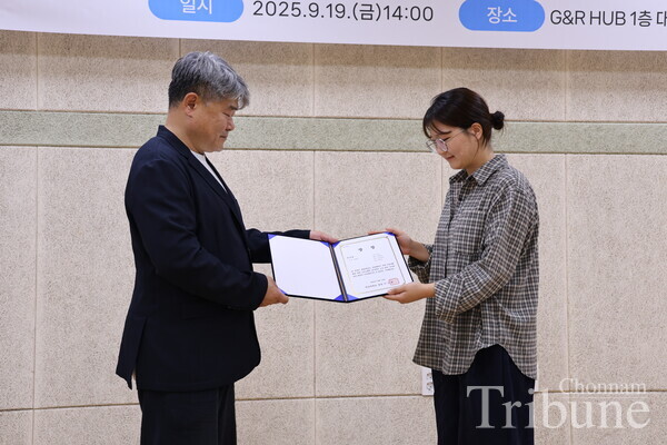 A student is receiving an award of excellence.