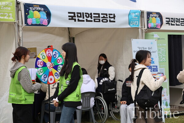 Some students are scattered around a booth.