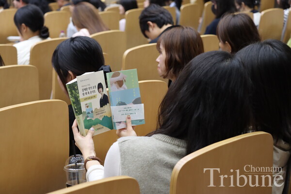 Audience members look at the books of writer Kim Ae-ran at the 'One Book Talk Concert'.